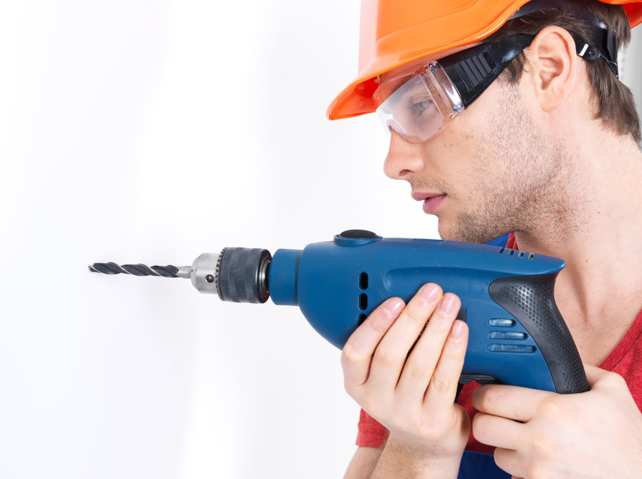 A man drilling a hole in the wall.